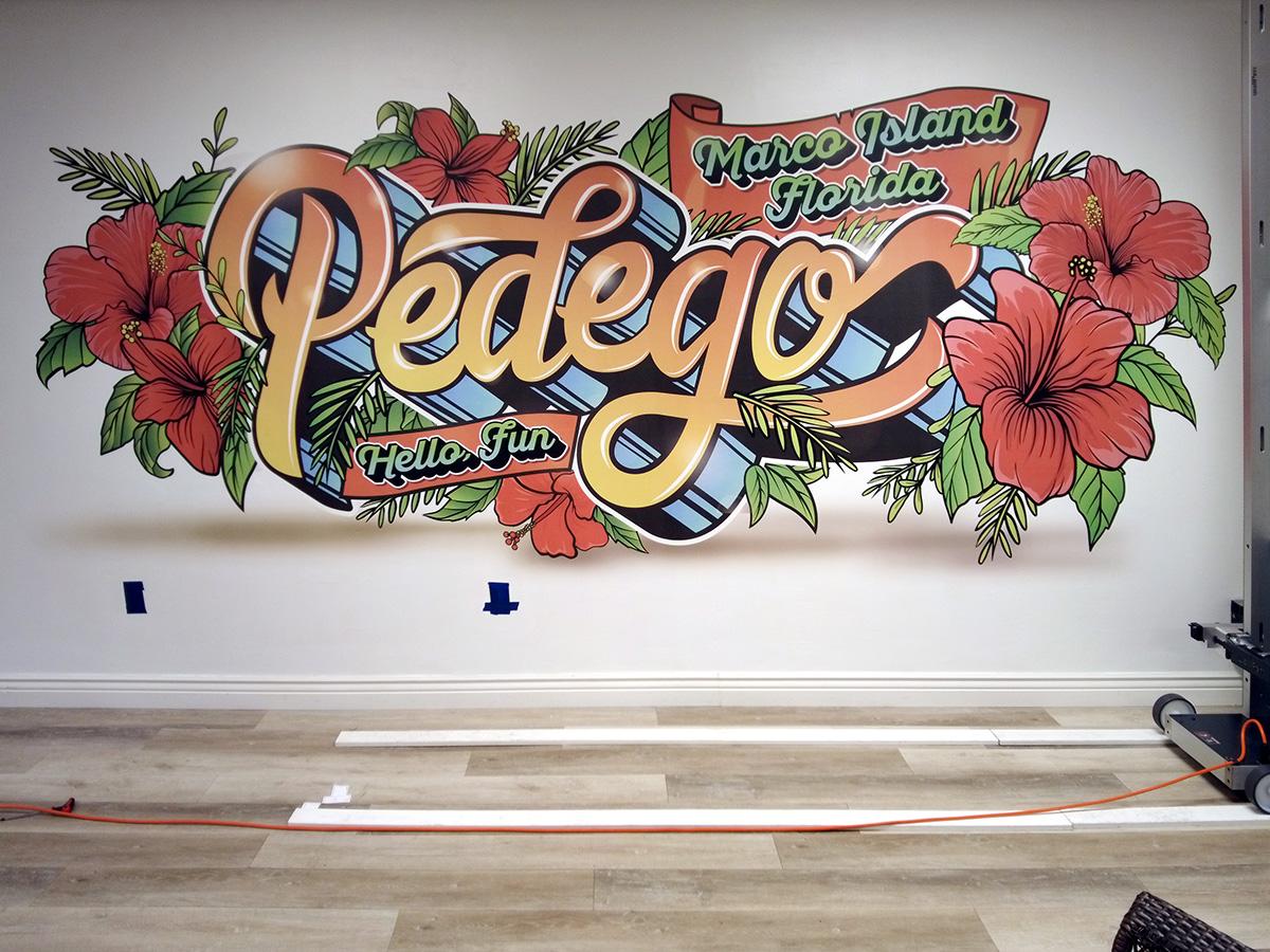 Pedego logo signage printed on wall
