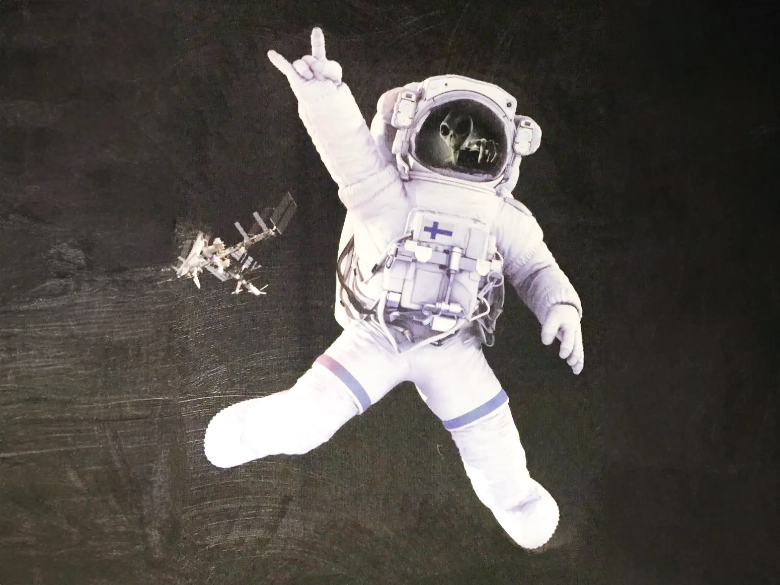 An astronaut rocking out as they float thru space printed on textured concrete.
